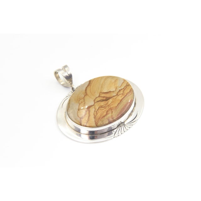This Wildhorse Jasper depicts a stunning mountainous desert scene. The oval piece of jasper is bezel set into a sterling...
