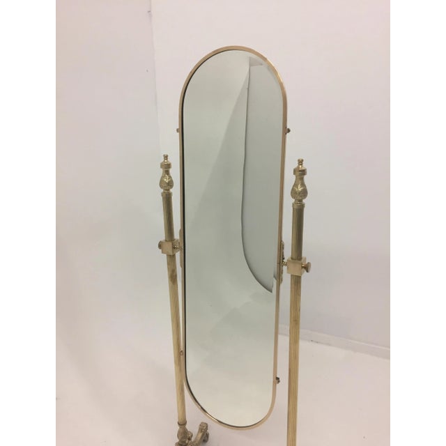 A very pretty Brass Recoco Chaval mirror having ornate feet and lovely oval full length mirror. Was just professionally...