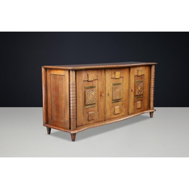 Exceptional French Art Deco sideboard from the 1930s, masterfully crafted in solid oak and distinguished by an imposing...