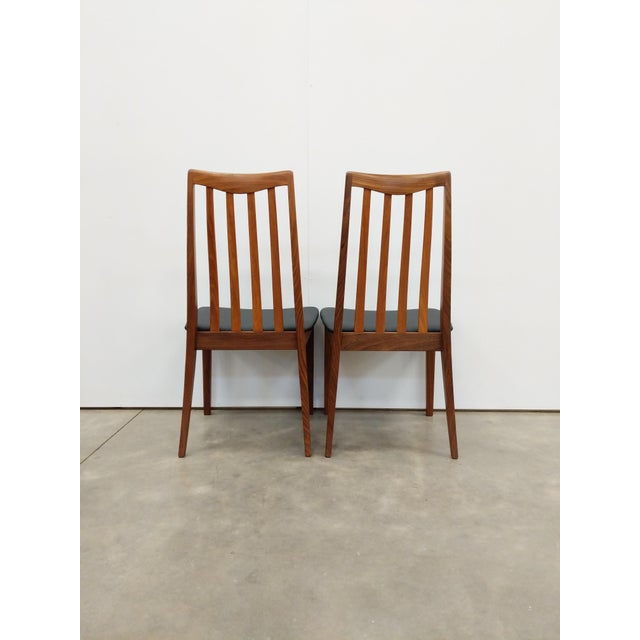 Pair of authentic vintage mid century modern dining chairs. In teak and afrormosia (aka African teak) woods. Designed by...