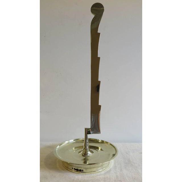 A mid-century brass sculpture dish attributed to Tommi Parzinger. Solid Brass sculpture mounted to the center of a brass...