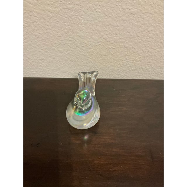 This captivating decorative bird sculpture is crafted from glass. The bird’s form is sleek and modern, with a rounded...