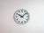 This wall clock was produced by Siemens in Germany during the 1970s. It features a grey iron frame, a metal dial and a...