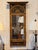 A French Empire pier mirror, the projecting cornice carved with gadrooned and egg and dart moldings above a black ground...