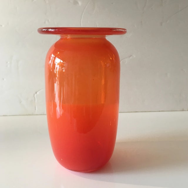Fabulous and richly colored orange handblown art glass vase. It has two shades of orange with the top being lighter and...