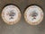 A well-matched pair of Delft polychrome plates, each painted with a central floral urn in blue, green, orange, and...
