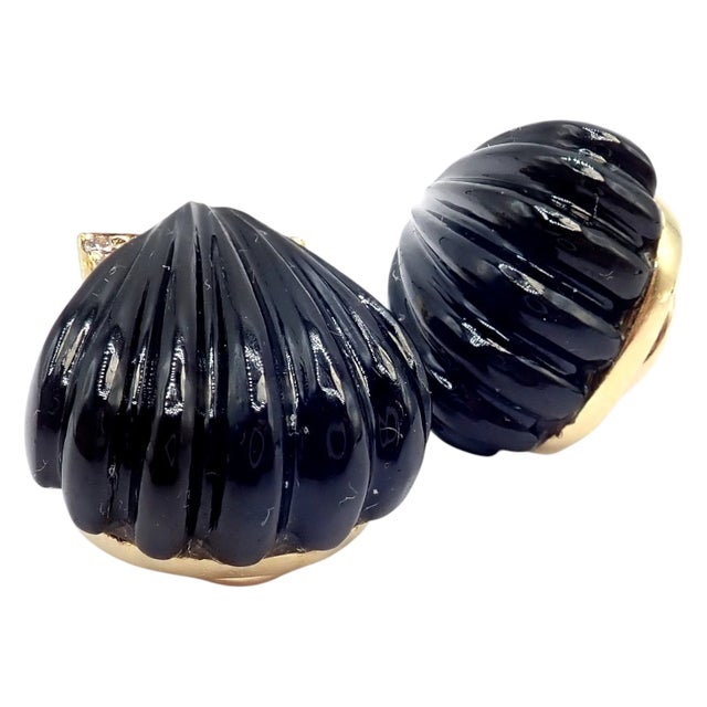 Vintage Estate Cartier yellow gold earrings showcase sculptural black onyx carved into elegant shell motifs, embodying...