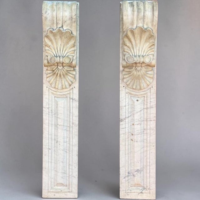 This is a pair of Italian Neo-Classical style antique carved marble pilasters or corbels. They have palmettes or shells...