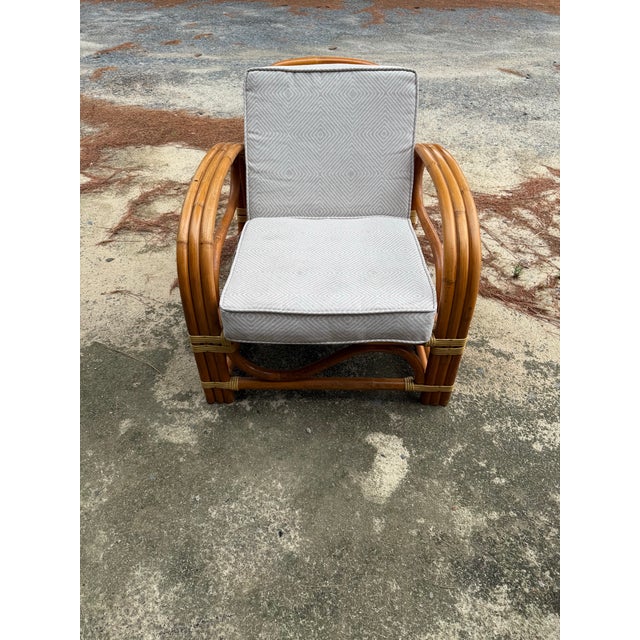 A beautiful Paul Frankl style bamboo and rattan, three strand pretzel design lounge chair with S front design. All...