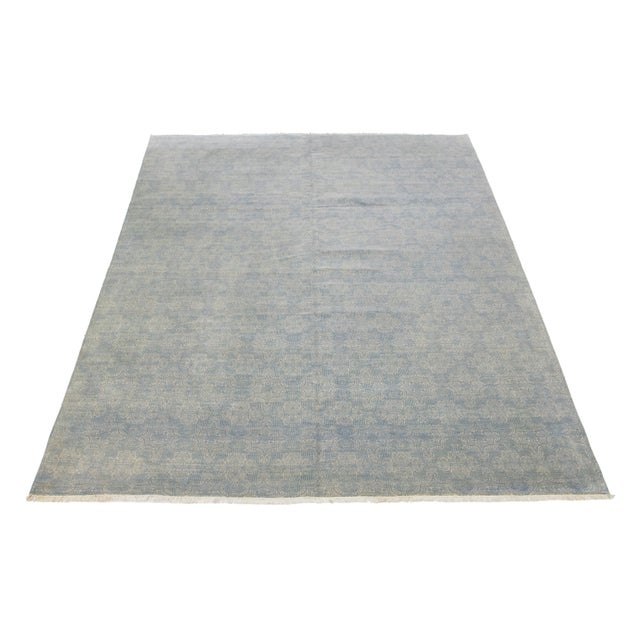 This exquisite contemporary rug is hand-knotted from high-quality wool and showcases a striking gray and blue color...