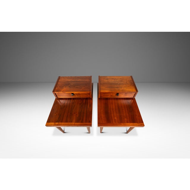 This stylish pair of American of Martinsville nightstands showcases classic mid-century modern design and refined...