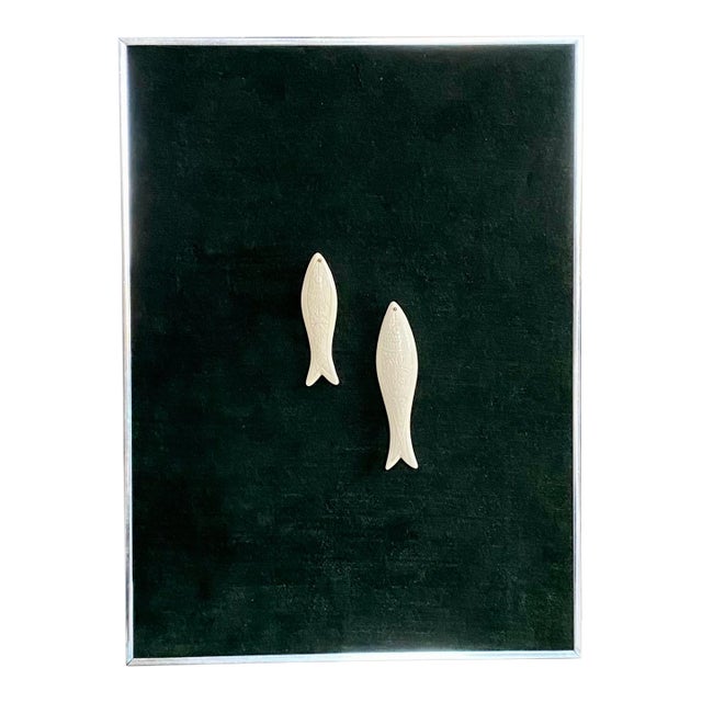 A fun framed set of carved fish pendants mounted to a forest green soft textile and framed in a chrome finished, slim...