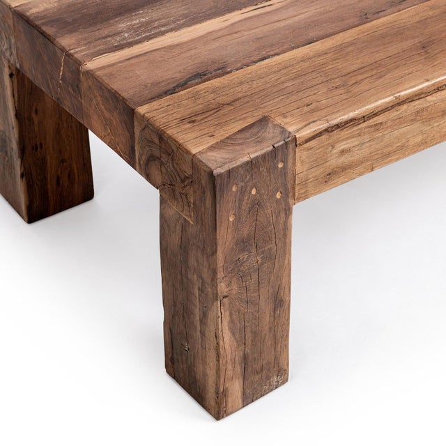 Solid salvaged hardwood coffee table crafted from reclaimed timber in a bold block silhouette that highlights the natural...