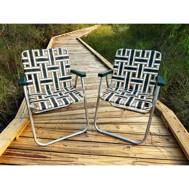 A wonderfully nostalgic pair of vintage RIO Backyard Collection aluminum webbed patio chairs, featuring an exceptionally...