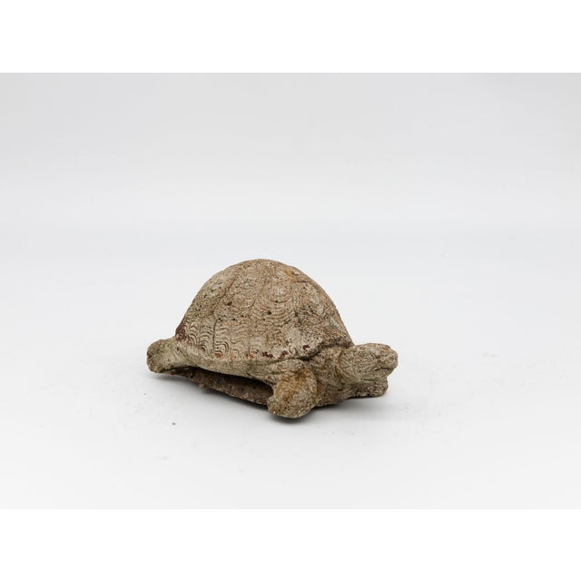 Shell patterned in layered, feathered arcs, this reconstituted stone tortoise in warm earthy tones with traces of...
