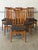 This set of six dining chairs features tall backrests composed of vertical slats. The gently curved frames offer a...