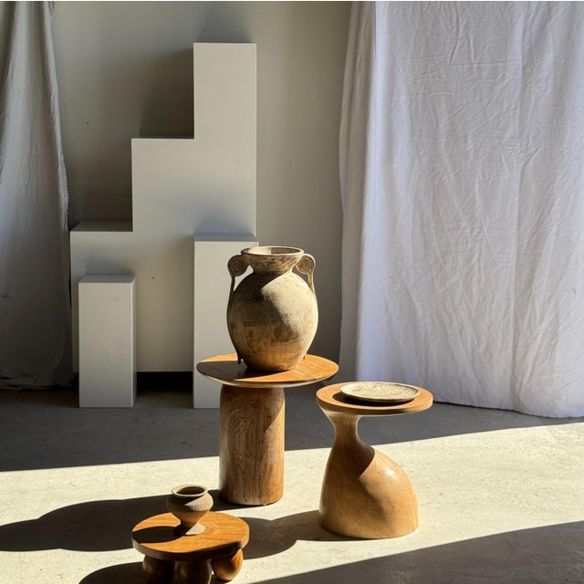 Solid teak side table with a circular top and column base. An elegant and timeless geometric shape. The piece is stable...