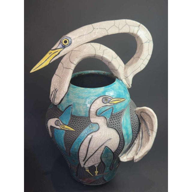 I’m selling an unusually shaped tall Raku pottery vase. It is signed underneath as shown by listed artist Robin Duke...