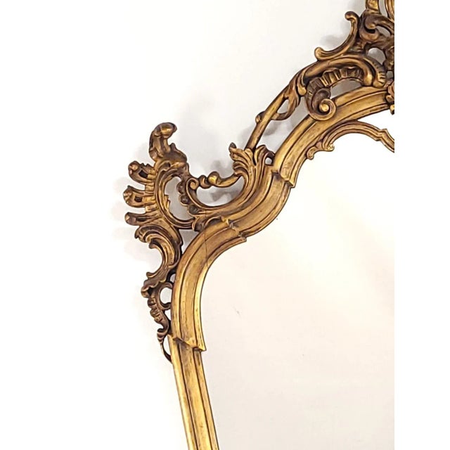 A vintage Italian giltwood mirror, a stylized version of 18th-century design, circa 1920.