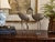 A charming vintage pair of metal crane sculptures featuring beautifully detailed plumage, elegant proportions, and...