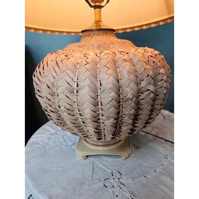 Offering a striking mid-century Palm Beach Regency style rattan table lamp, by Robert Abbey.. This braided basket form...