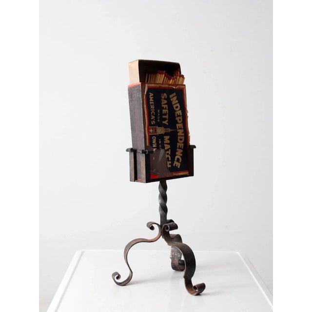 Antique oversize match box with wrought iron stand, designed to hold and display a large match box near the hearth. The...