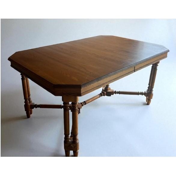 This vintage solid wood dining table brings both character and functionality to any dining space. The table features a...