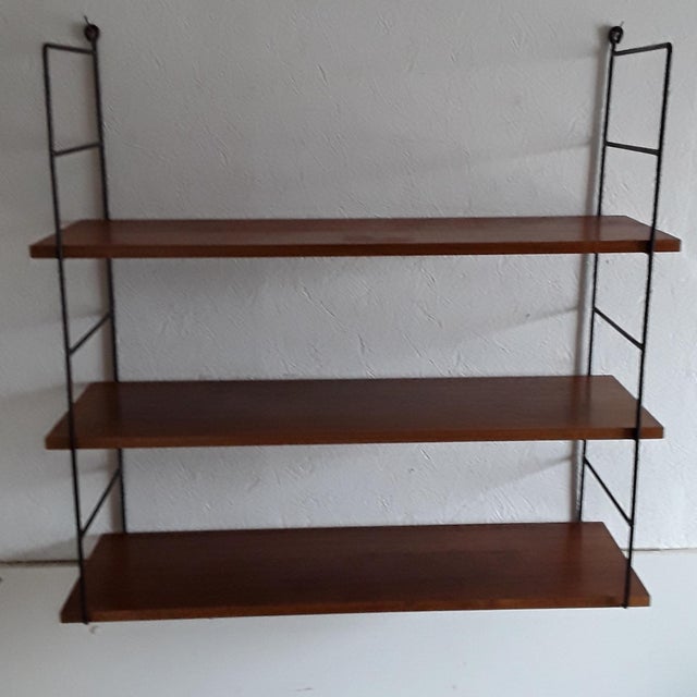Vintage 3-Tier String Shelf with Black Wire Frame & Shelves in Teak Veneer Chipboard, 1970s, in Good conditions. Designed...