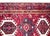 A beautiful MId-20th century Persian Heriz runner with several large stylized floral medallions living amidst a densely...