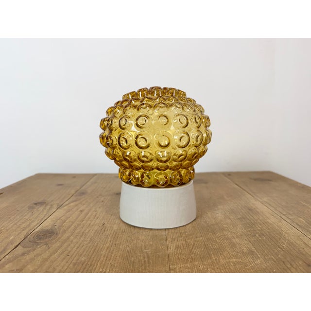 Vintage industrial ceiling or wall light made in former Czechoslivakia during the 1970s. It features a white porcelain...