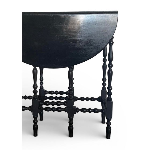 Streamlined drop leaf table with turned wood legs. The two leafs extend to form an oval shape. 10.25” depth of table with...