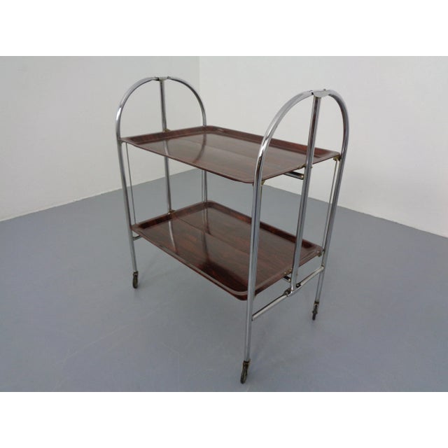 Rolling and collapsible dinette in rosewood optics from the 1970s. This piece has an attribution mark, I am sure that it...