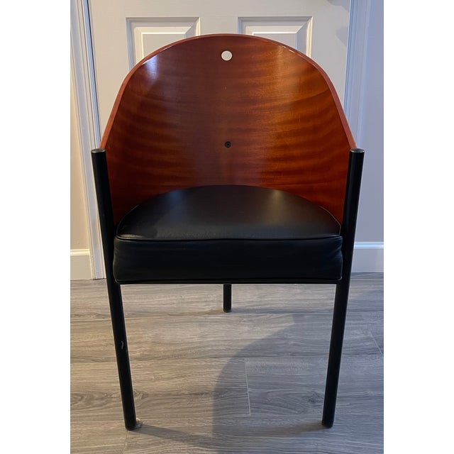 Replica of Phillipe Starck dining chair in mahogany color wood and black leather seat cushion, mid 1980’s. Excellent...