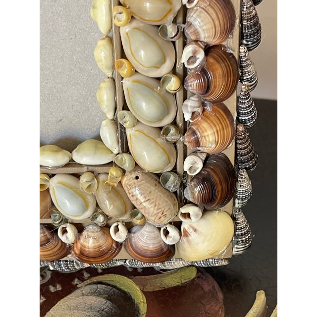 Beautiful elegant design sea shell encrusted photo frame in tan and brown natural colored shells in Tony Doucquett style.