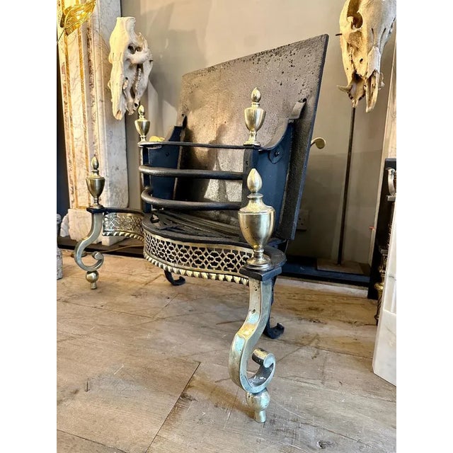 A large and very good quality late Georgian grate, from an 18th century design. The wrought iron bars topped with bulbous...