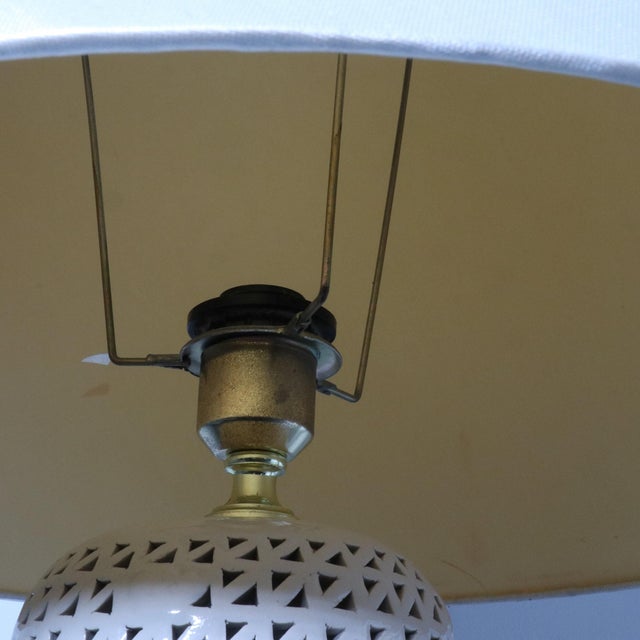 Large scale reticulated Blanc de Chine table lamps with shades and ebonized bases and brass fittings. Circa 1940’s....