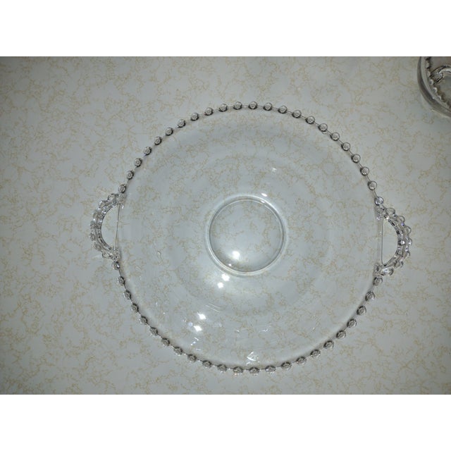 Five matching pieces to a set. There is a large platter (13.5 inches across, 11.5 inches on the platter face). There are...