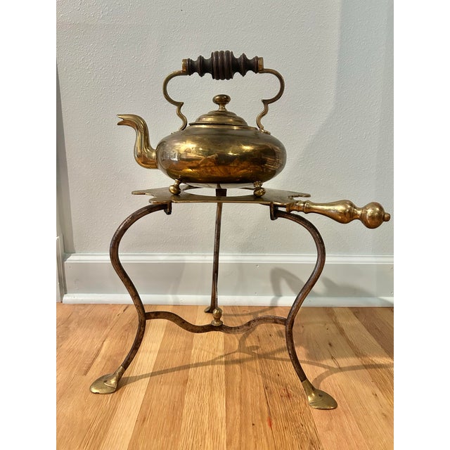 In the Victorian Era, these kettles on stands were used for keeping water warm near the fire for household use. This one...