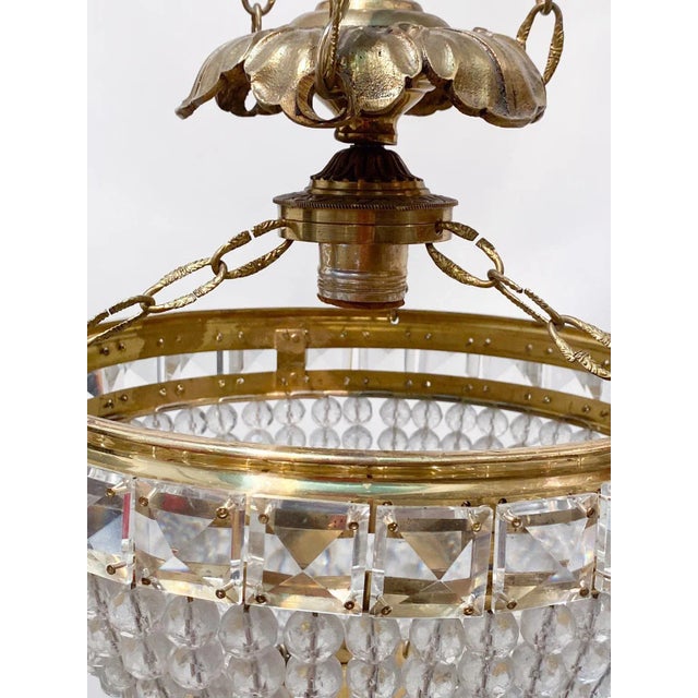 Mid-century chandelier with brass rim frame and vintage bead basket. Restored, rewired and it has one Edison base socket...