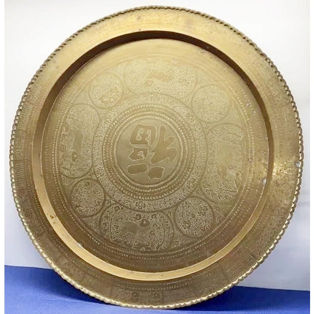 Hammered brass pie crust platter table from Asia, Thailand likely, on newer folding faux-bamboo wooden base, perfect for...