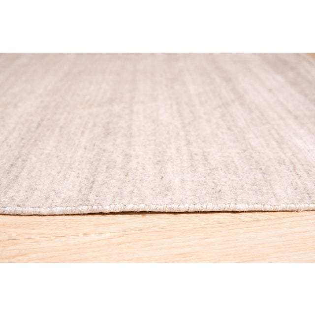 Maya Unique Beige Handmade Wool & Viscose Rug, Country of Origin: India. This exceptional piece showcases the meticulous...