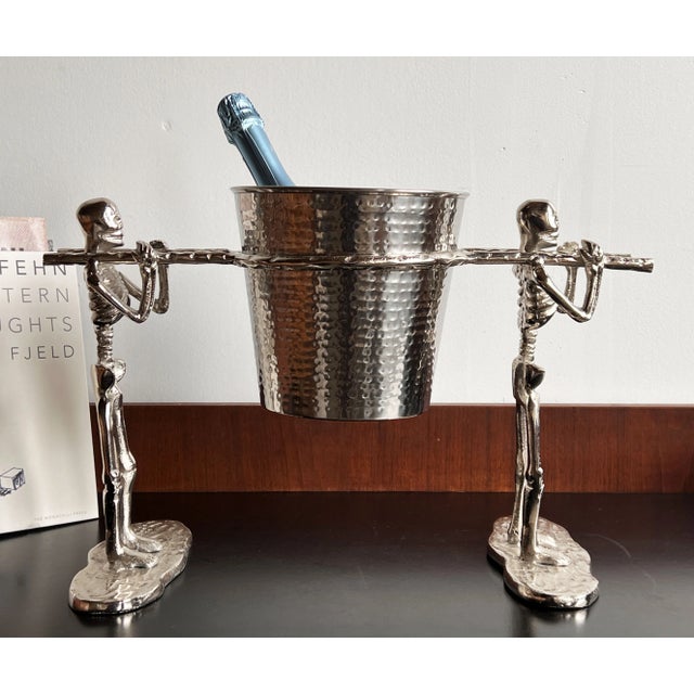Fabulous c.1990's chromed metal ice bucket, featuring a pair of skeleton pallbearers. Very unique design, with a removable...
