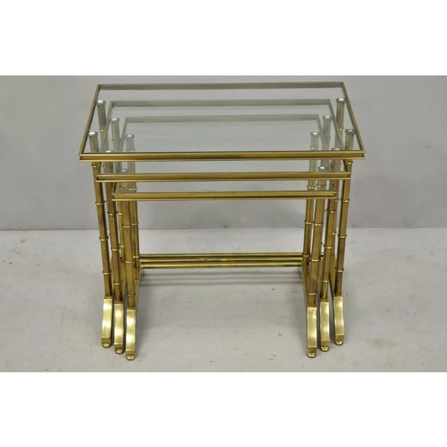 Vintage Hollywood Regency Brass Faux Bamboo Glass Top Nesting Side Tables - Set of 3. Styled after Mastercraft. Item...