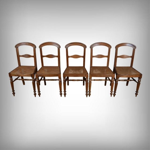 This set of five solid oak cane chairs, dating from the Louis-Philippe period, embodies the understated elegance and...
