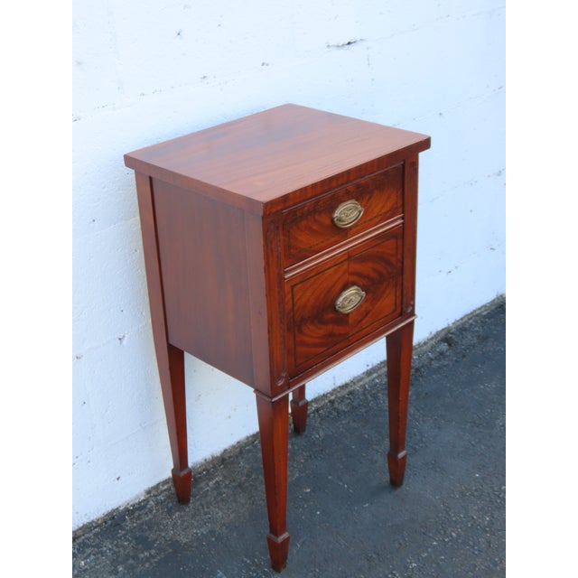 This beautiful Nightstand is made of wood, mahogany, flame mahogany, and veneer. This classic Nightstand feature American...