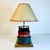 This accent table lamp is delightful. It has an Arts & Crafts style featuring a stack of three little storage boxes with...
