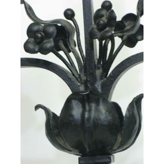 A very special and unique large pair of continental black iron Candelabras—three-arm for large candles--adorned with...
