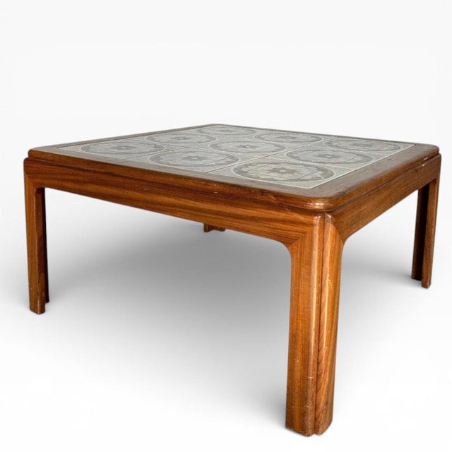 This vintage teak coffee table is a striking mid century modern table that brings both style and function to your living...