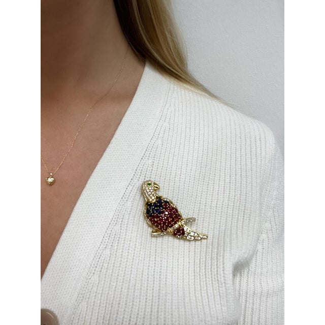 This fun little parrot is a perfect friend for your shoulder! Containing numerous top quality round brilliant and baguette...