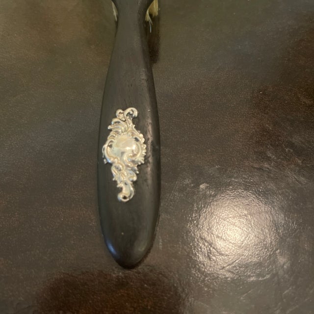 Antique Victorian ebony dresser brush. Made of ebony and embellished with a monogrammable Louis XV rococo style cartouche...